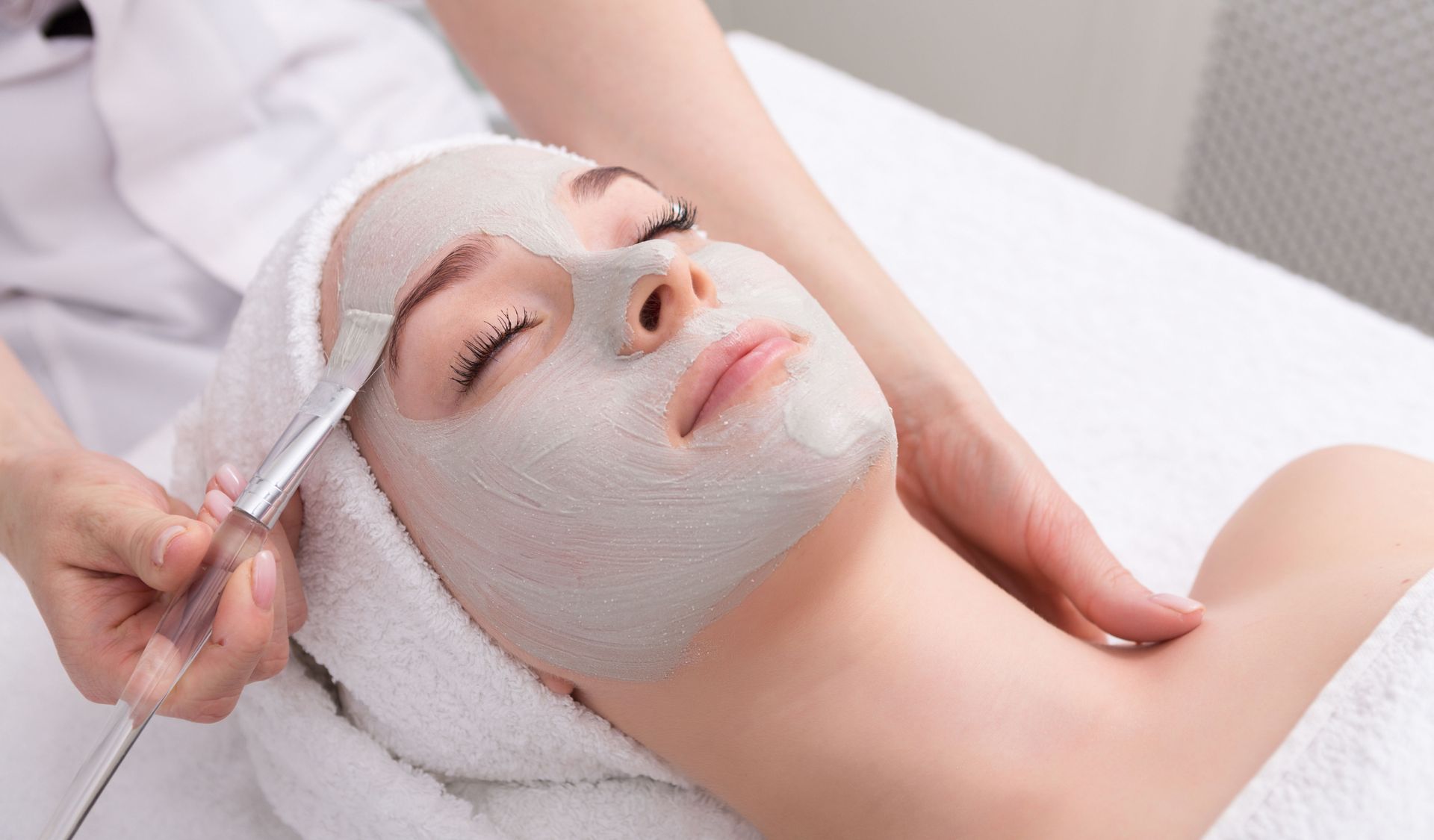 Facial mask applied with a brush during esthetics training at our Cincinnati esthetic school